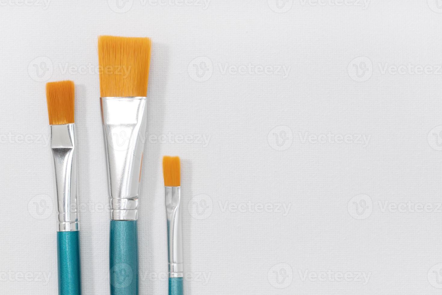 Set of paintbrushes on white canvas background. Copy space photo