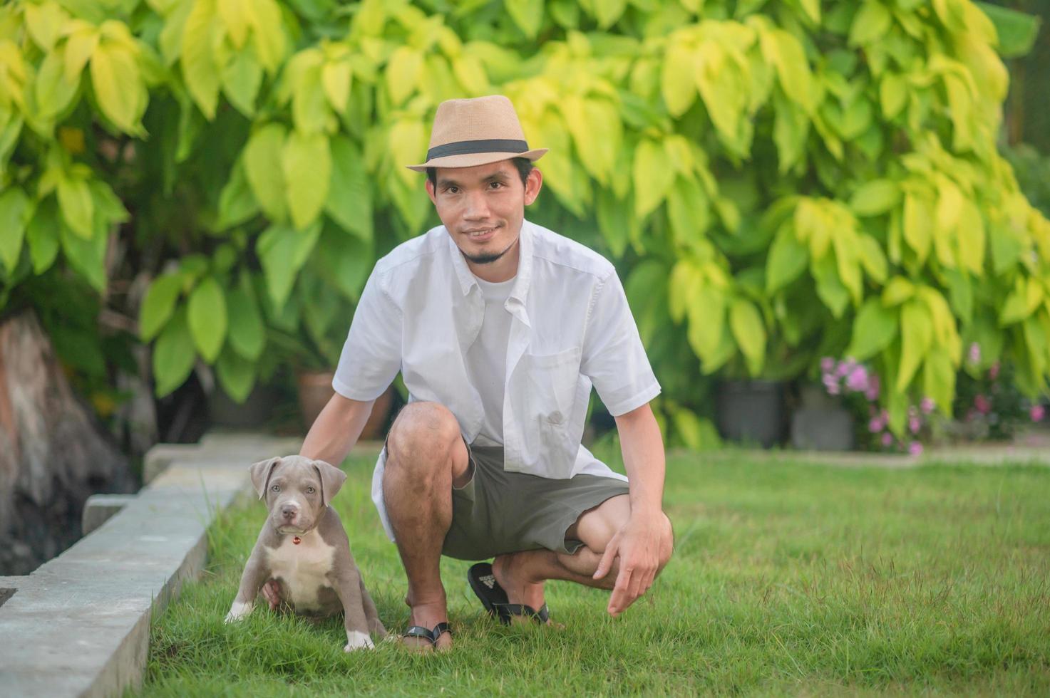 Man and dog puppy happy American bully photo