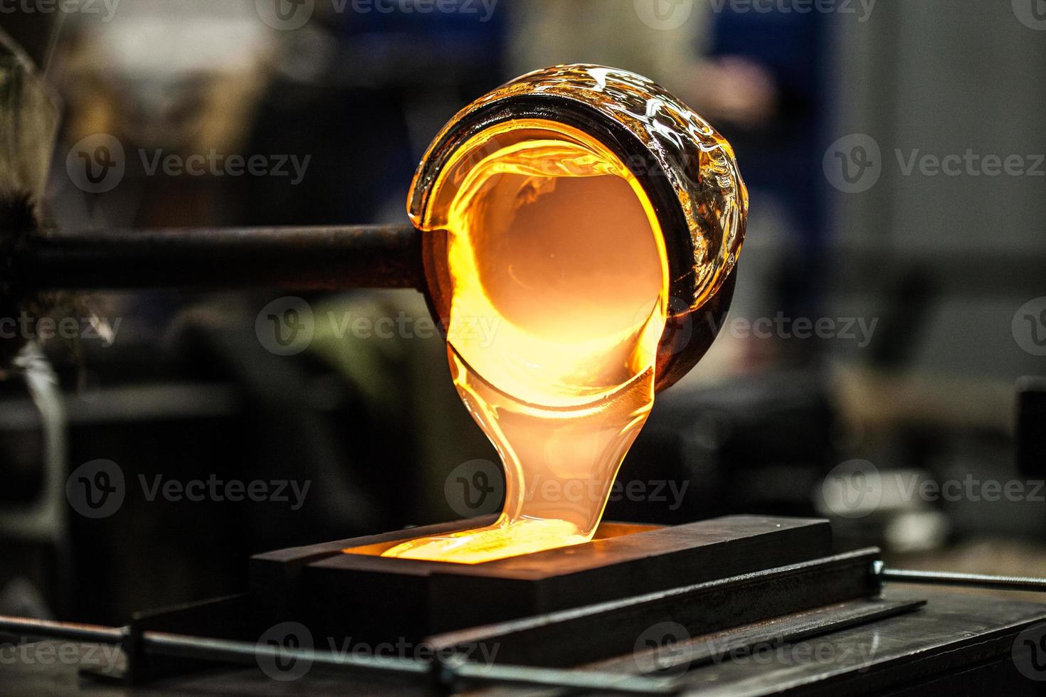 Pouring Melted Glass into Graphite Mold photo