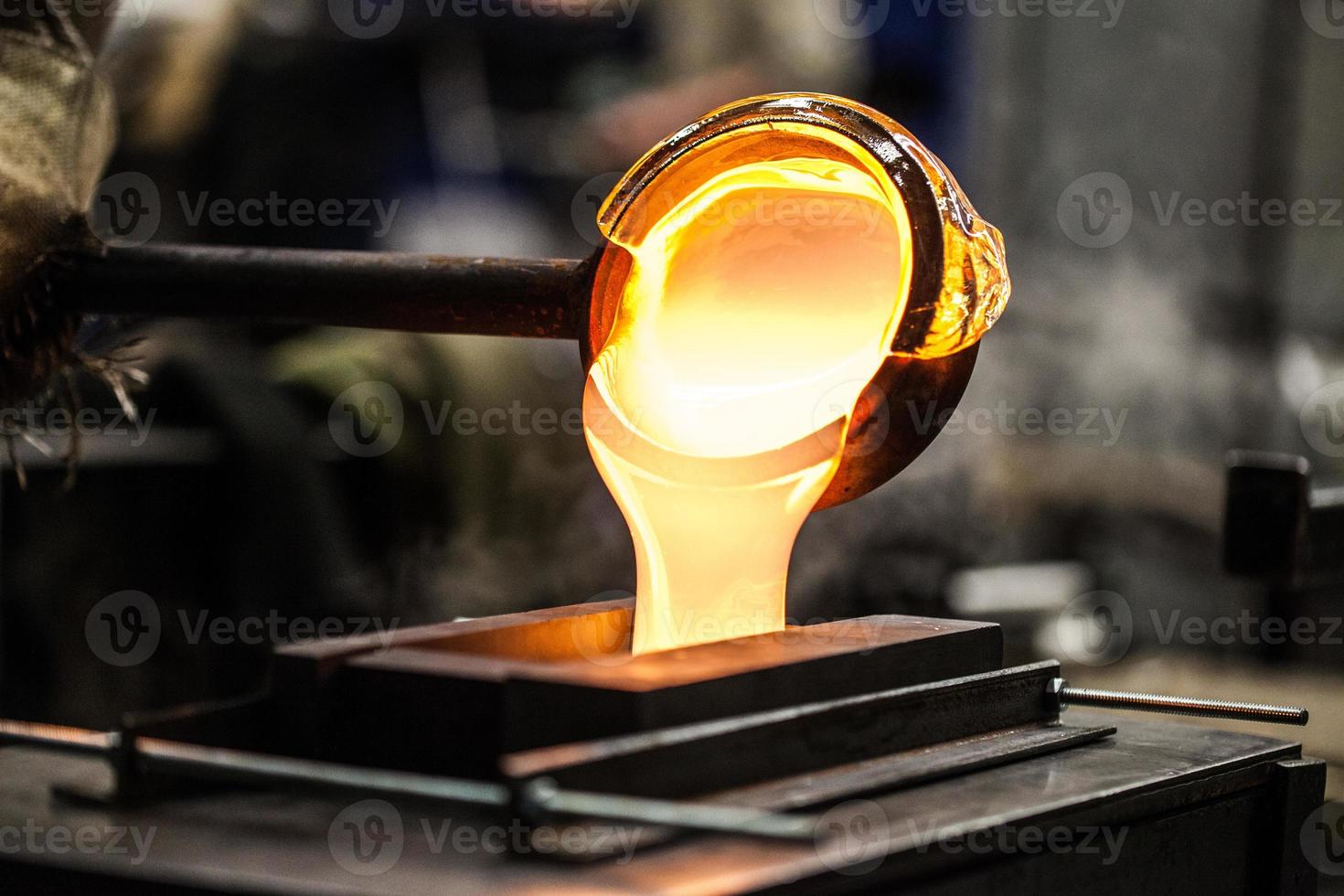 Pouring Melted Glass into Graphite Mold photo