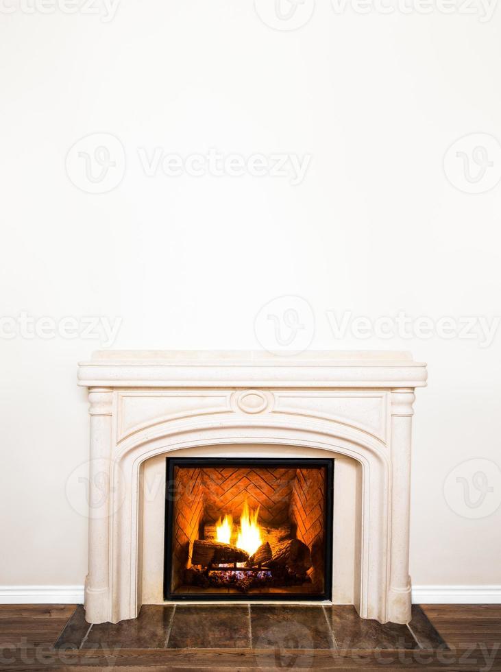 Lujosa chimenea de mármol blanco y pared vacía. foto