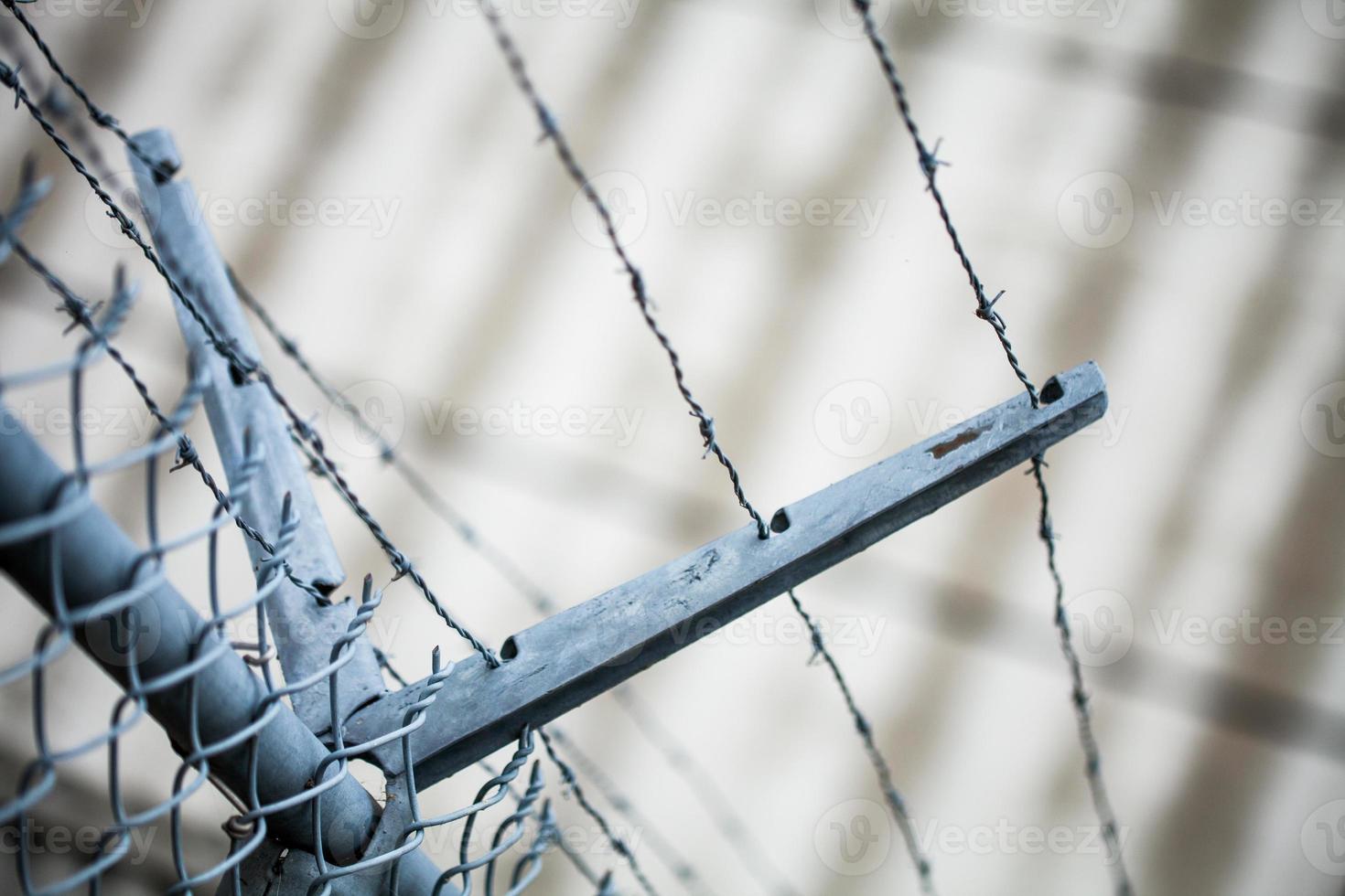 Outdoor Fence Detail of Sharp Barbwire Installation. photo