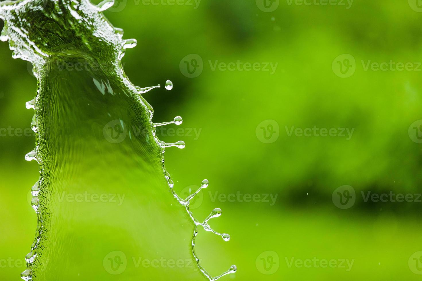 Falling Water Splash over Green Abstract Background with Room for you Text photo