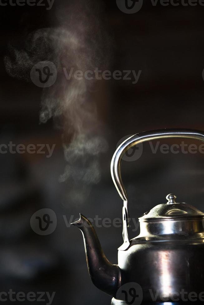 Boiling kettle on stove photo