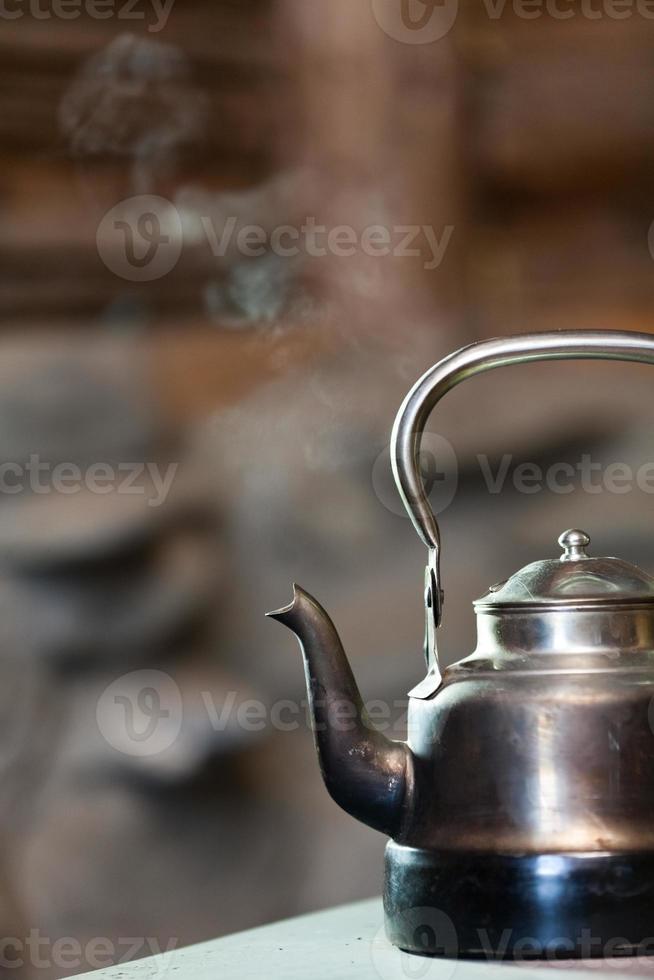 Boiling kettle on stove photo