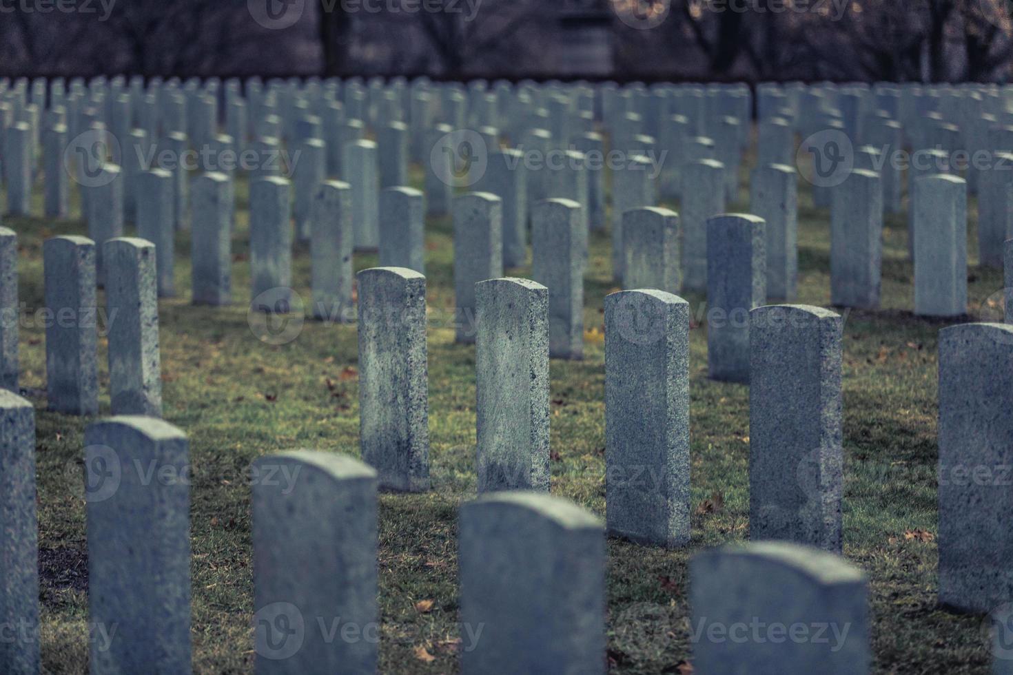 Back of Army Headstone and Graveyard Cemetery during a Sad Day of Autumn. photo