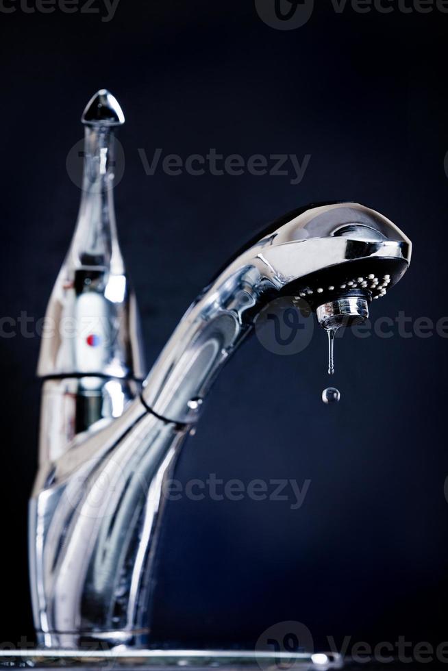 Broken kitchen sink closeup on black background photo