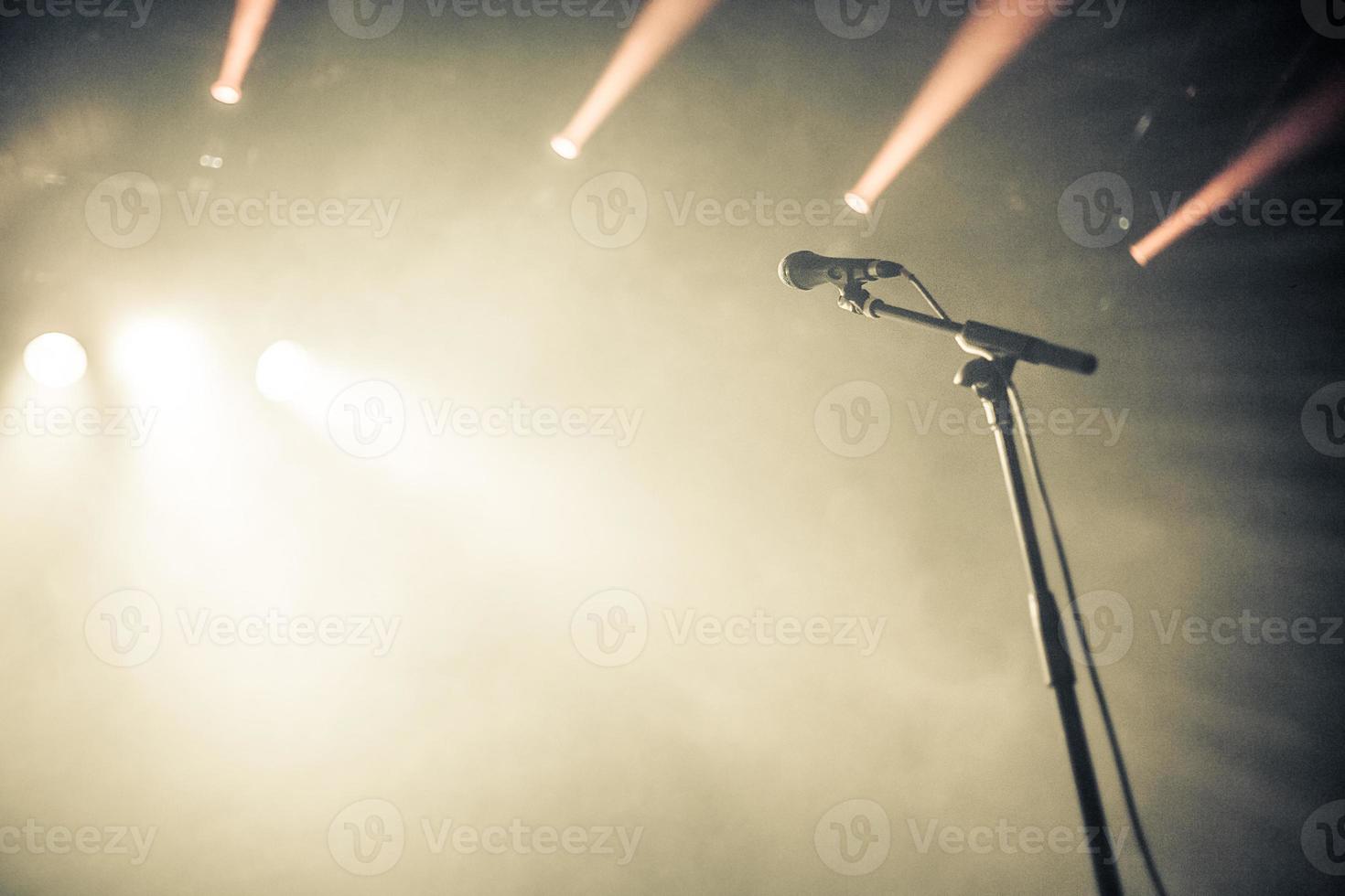 Microphone on empty stage waiting for a voice photo