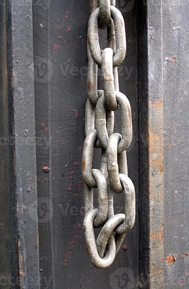 Chain hanging on metal photo