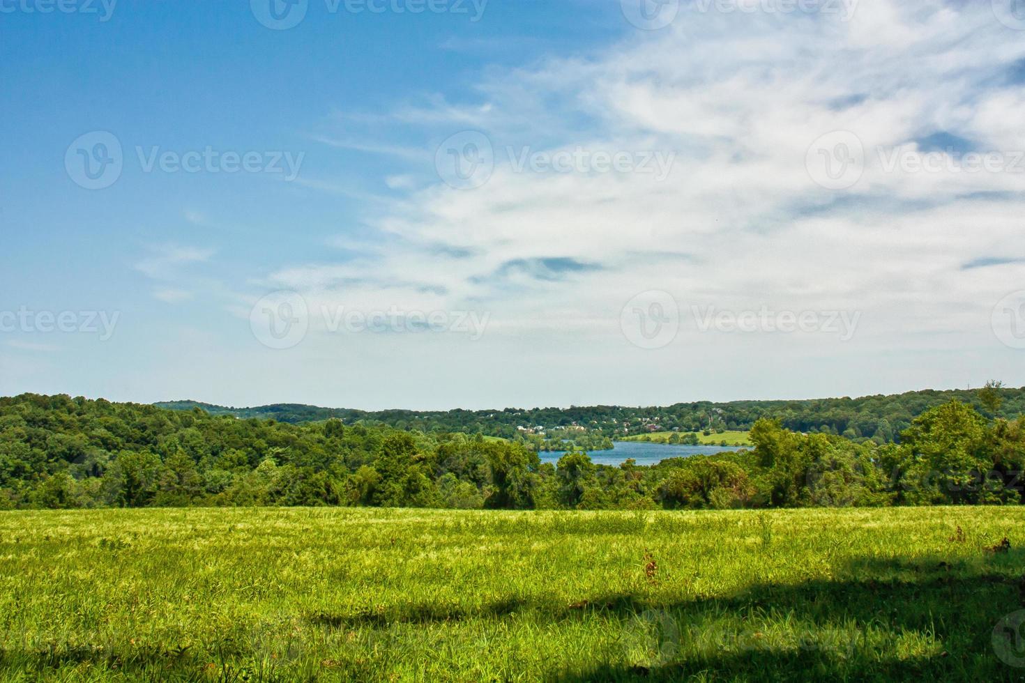 Field with distant lake photo