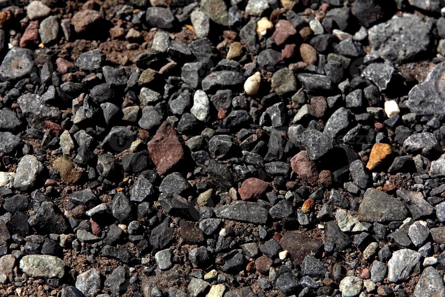 Various pebbles on ground photo