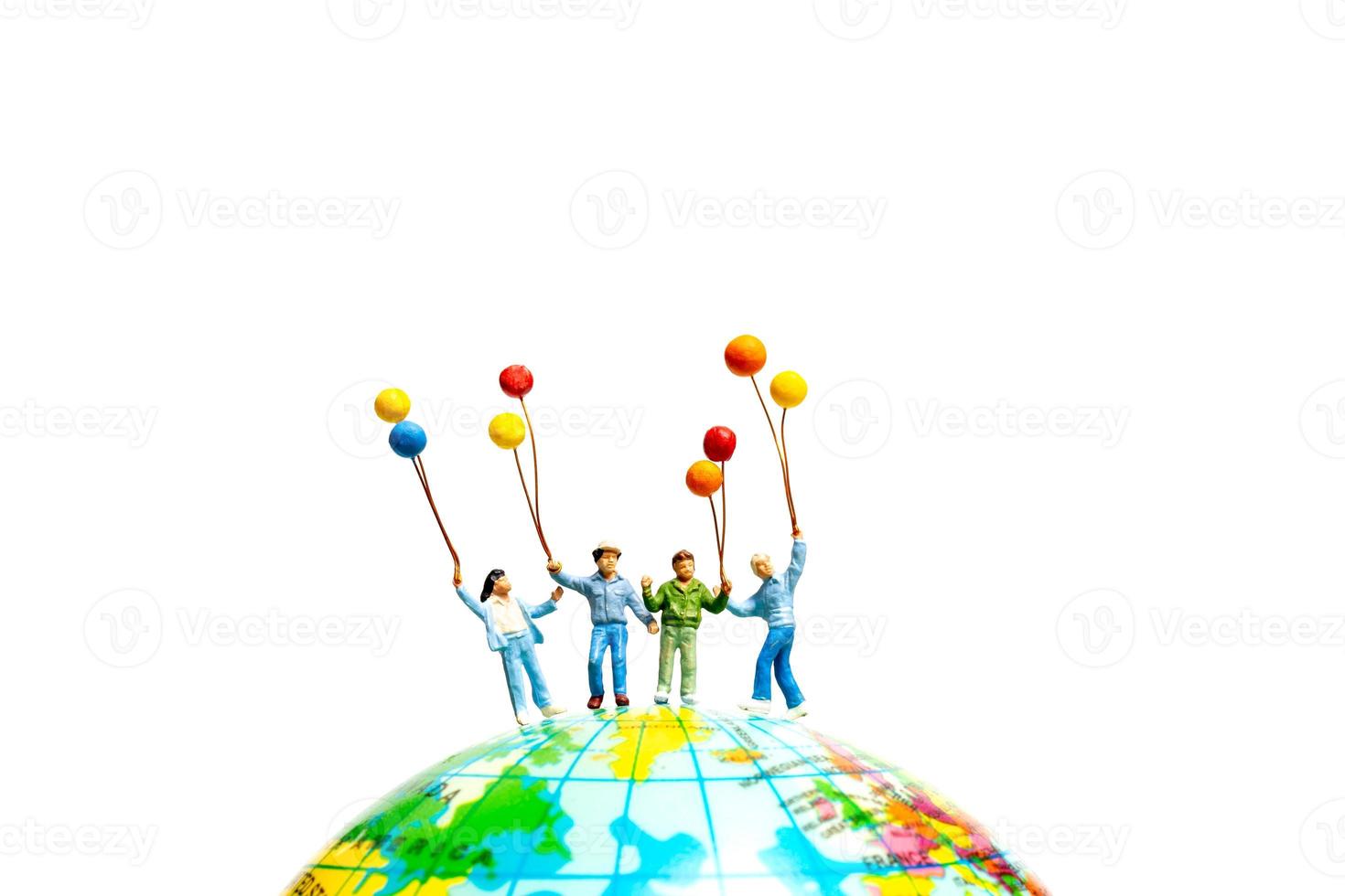 Miniature people , Childrens holding balloons standing on the globe photo