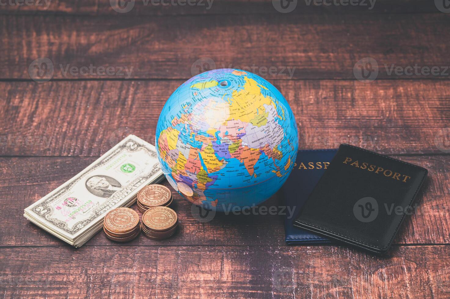 Money, passport and globe on wooden table photo