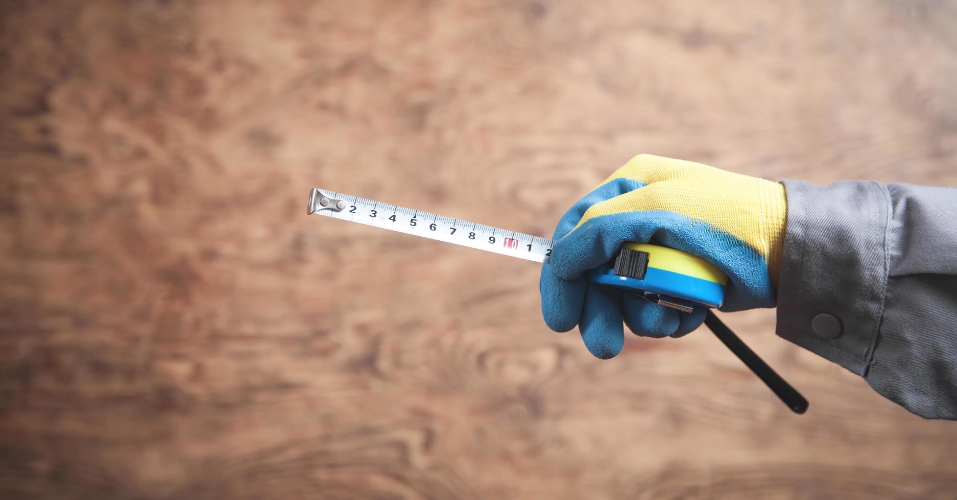 Worker holding a tape measure. photo