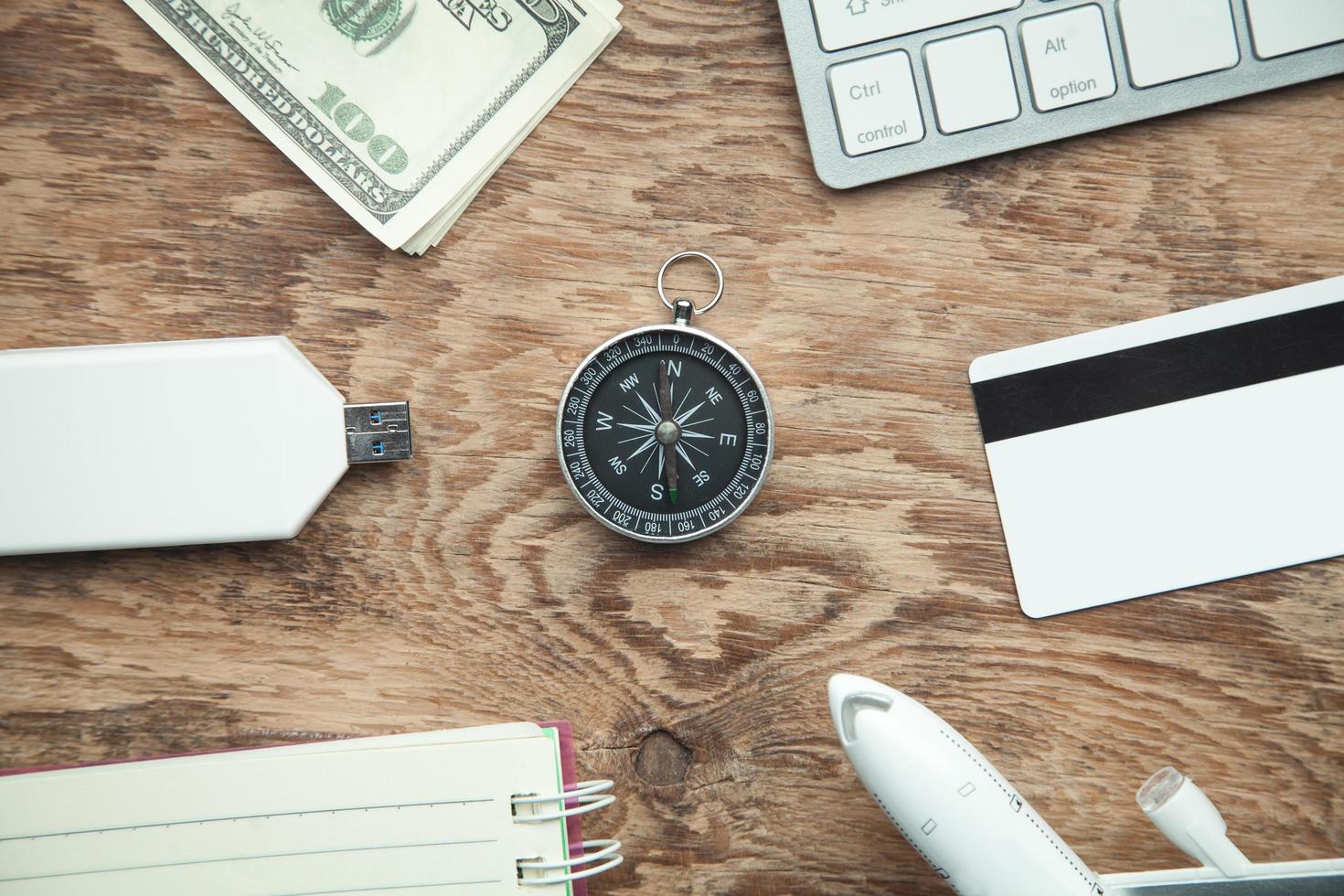 Compass and other objects on the wooden background. Travel photo