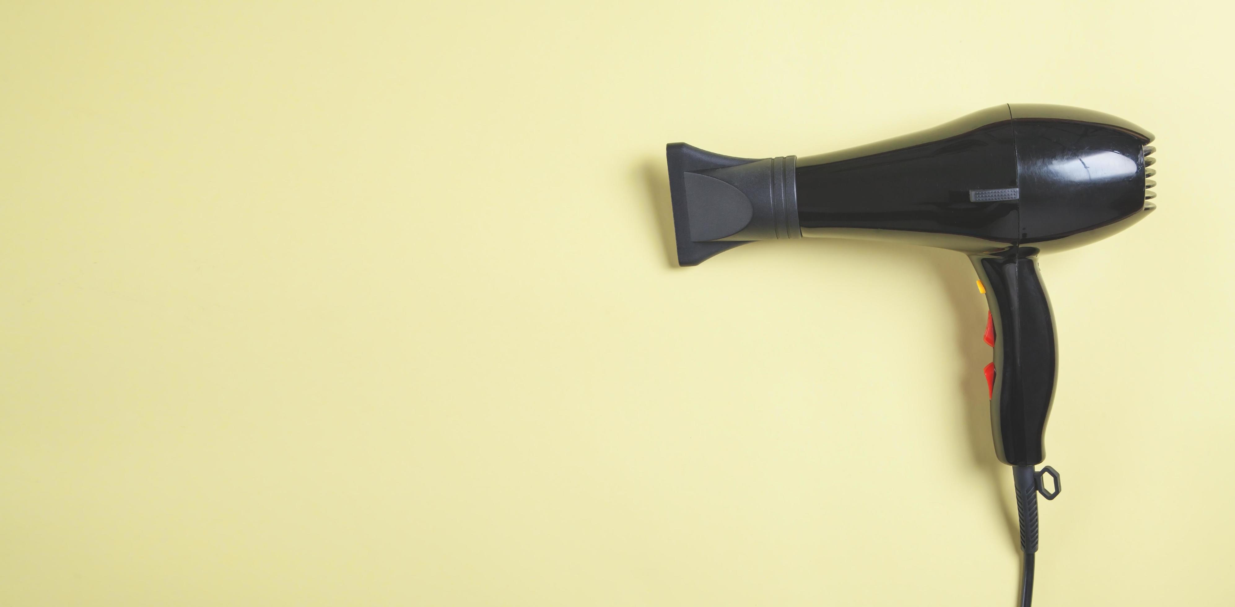 Hair dryer on the yellow background. 4340218 Stock Photo at Vecteezy