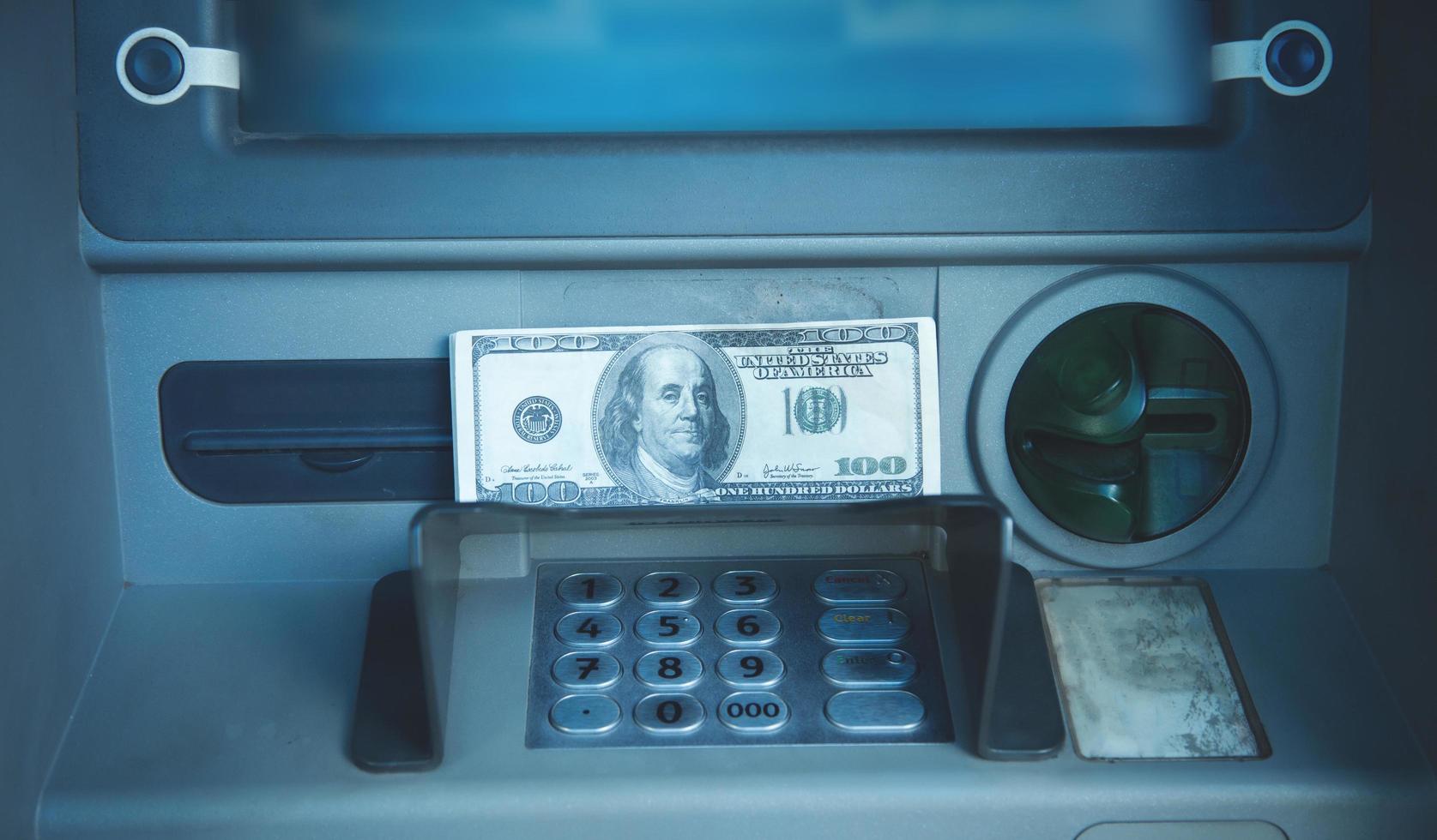 Dollar banknotes. ATM. Withdraw money photo