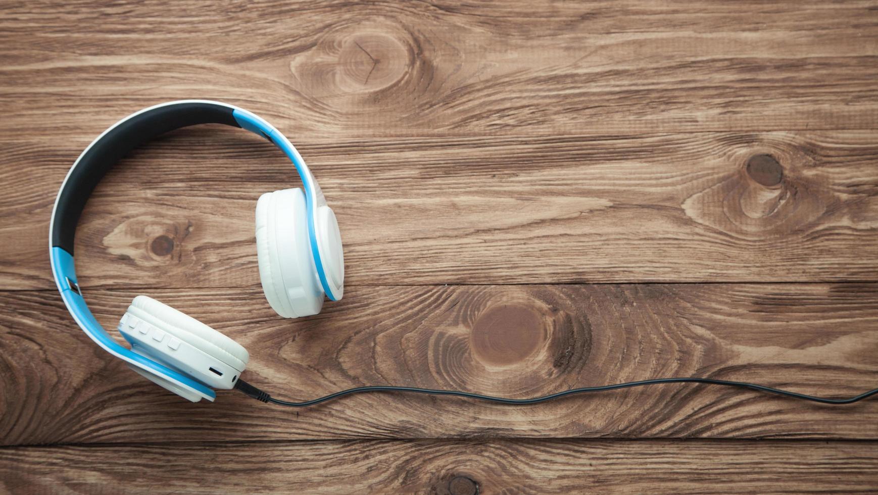 Wireless headphones on wooden table. photo