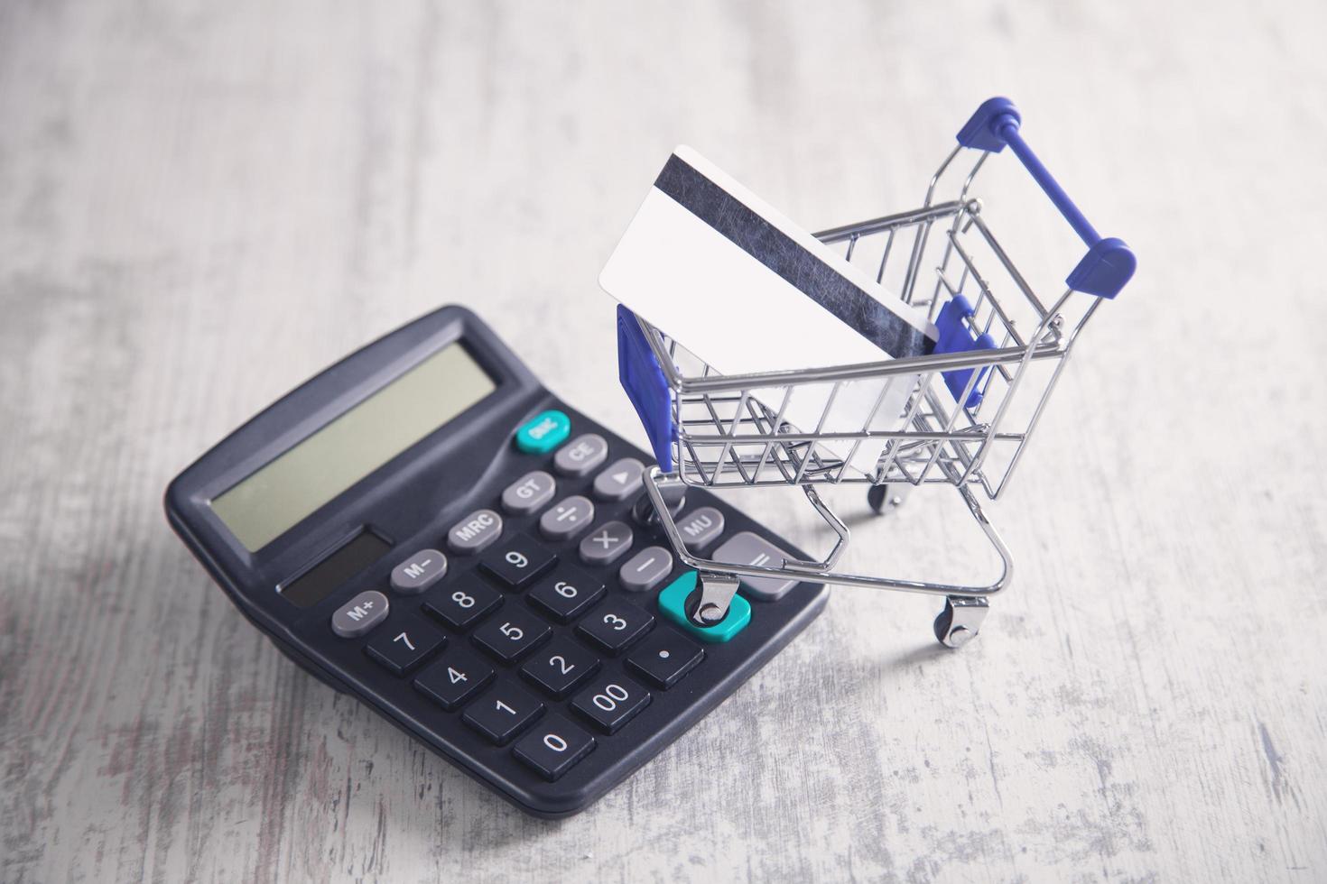 Shopping cart with credit card and calculator. photo