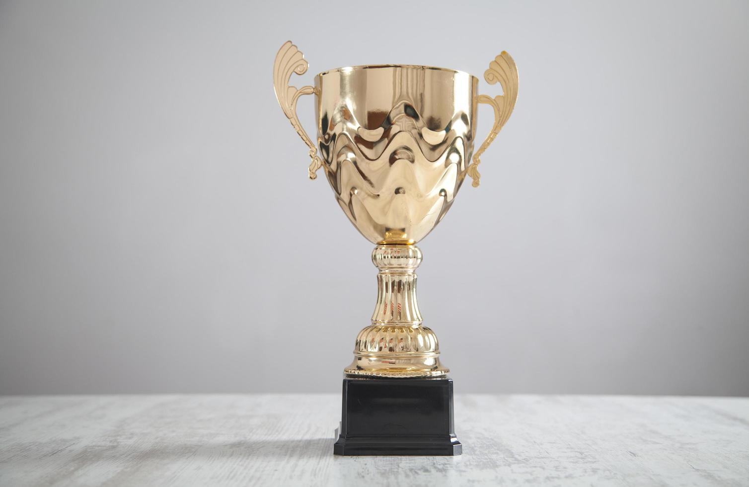 Golden trophy on white desk. Business, Success photo