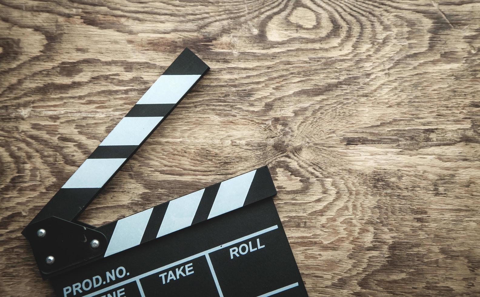 Movie clapper on wooden background. photo