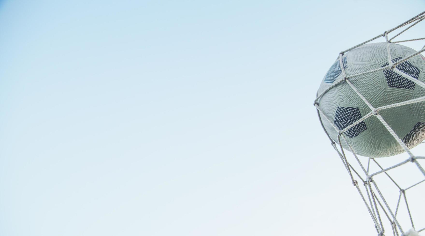 Soccer ball in the net of a goal. photo