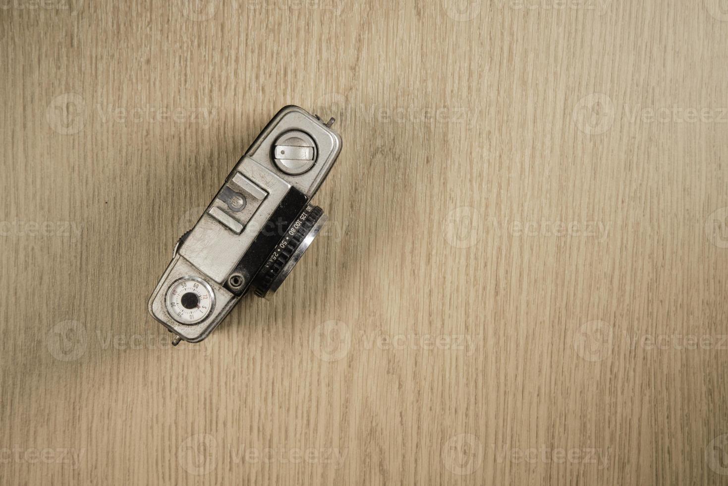 top view of retro camera on wooden table photo