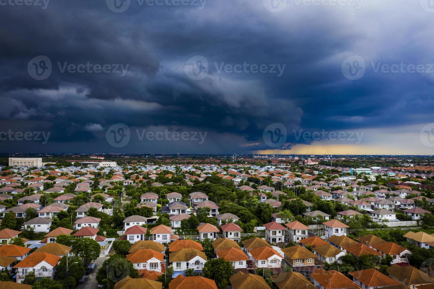 dark rainstorm over home village in bangkok thailand photo