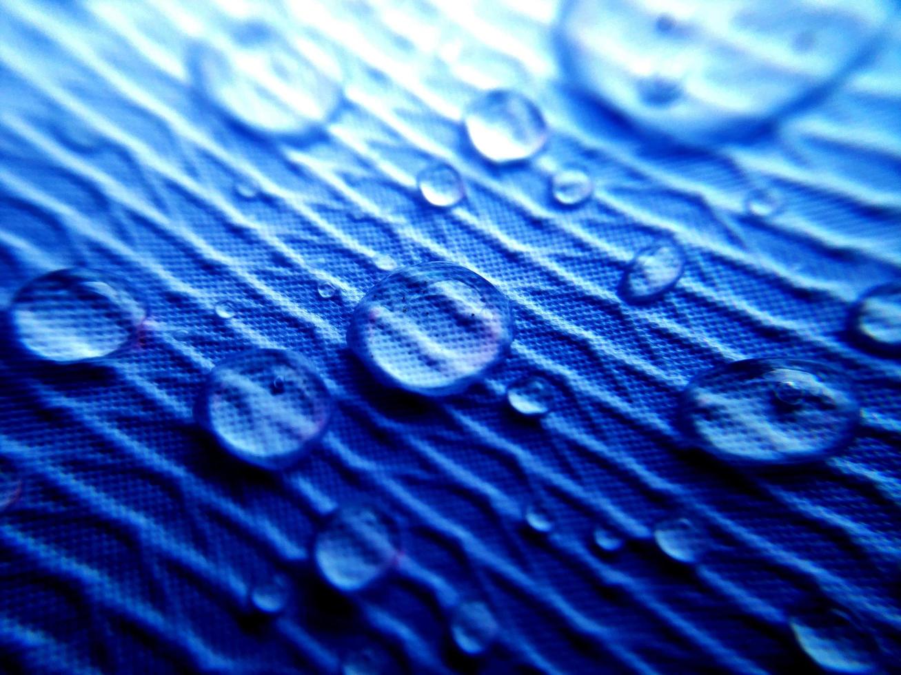 Water drop on fabric textured surface photo