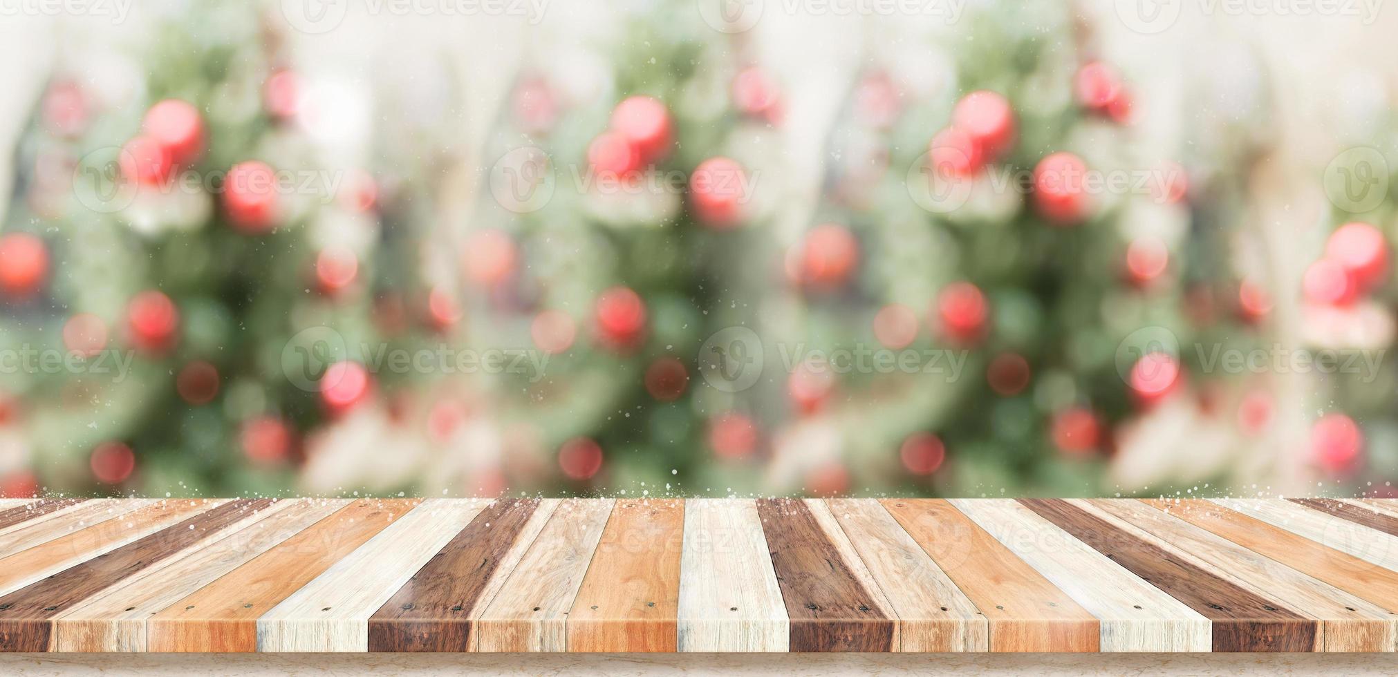 Empty rustic wood plank table top with abstract blur christmas tree photo