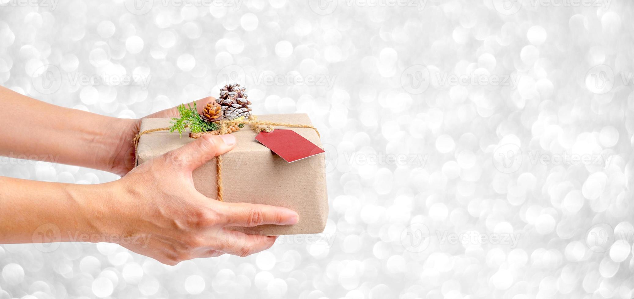 Close up woman hand holding Christmas present box photo