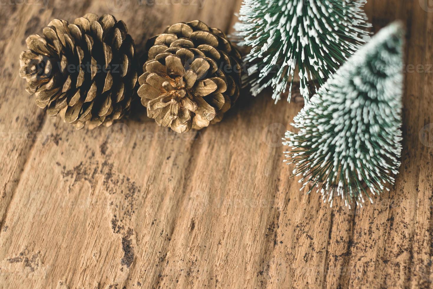 Top view of Christmas tree and gold pine cone on grunge wood photo