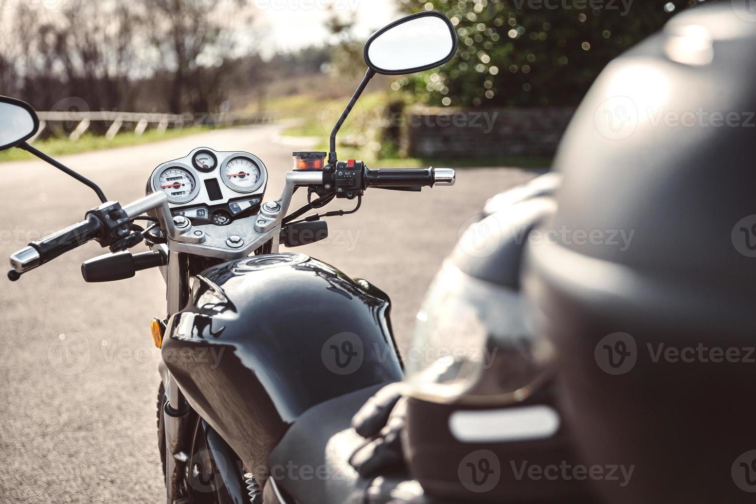 Black motorcycle on road over nature background photo