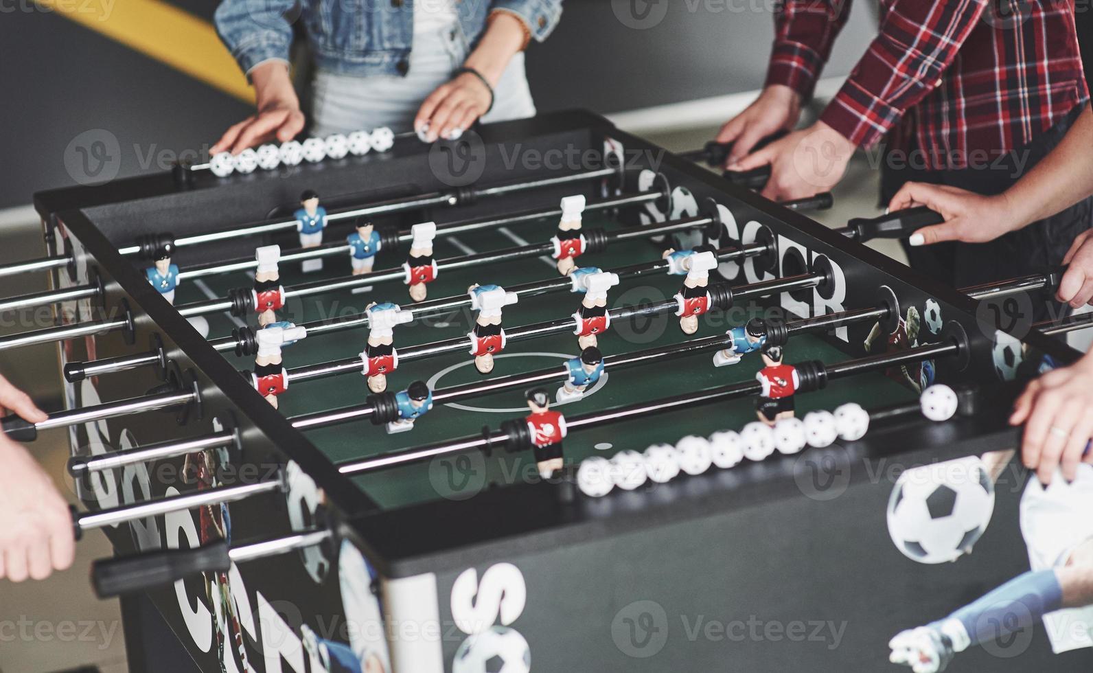 Friends together play board games, table football photo