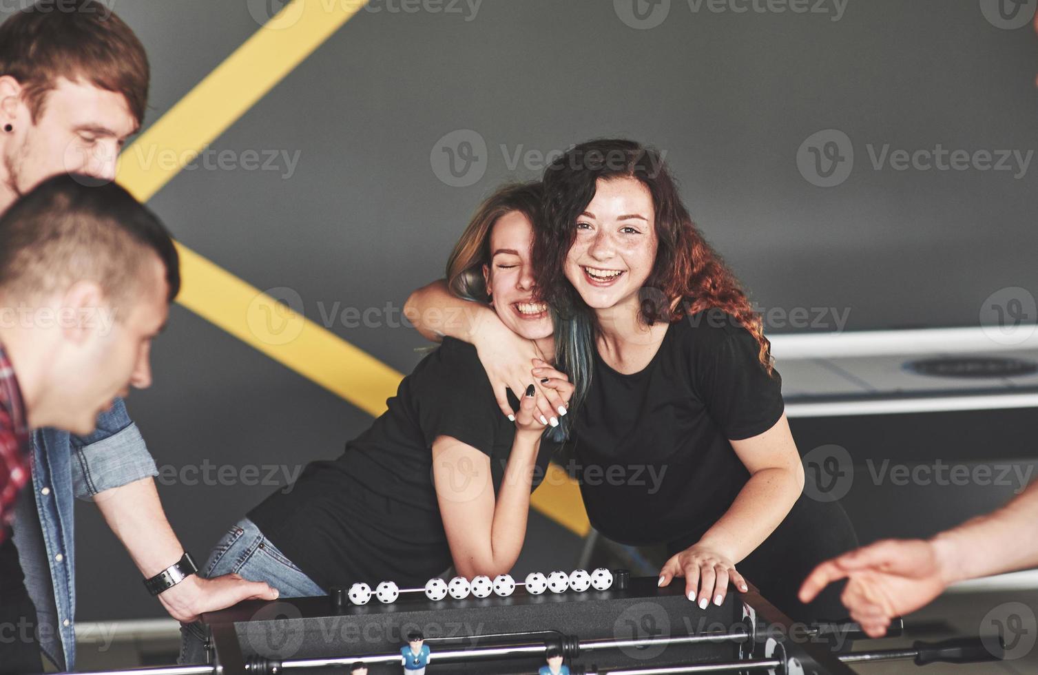 Friends together play board games, table football photo