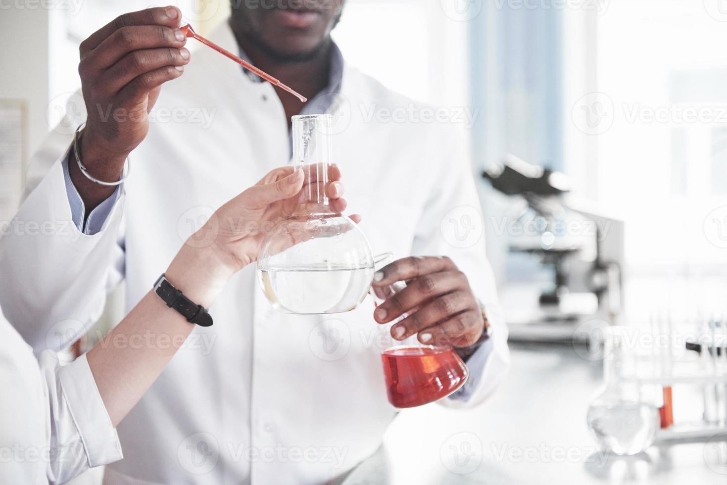 Experiments in the chemical laboratory. An experiment was carried out in a laboratory in transparent flasks photo