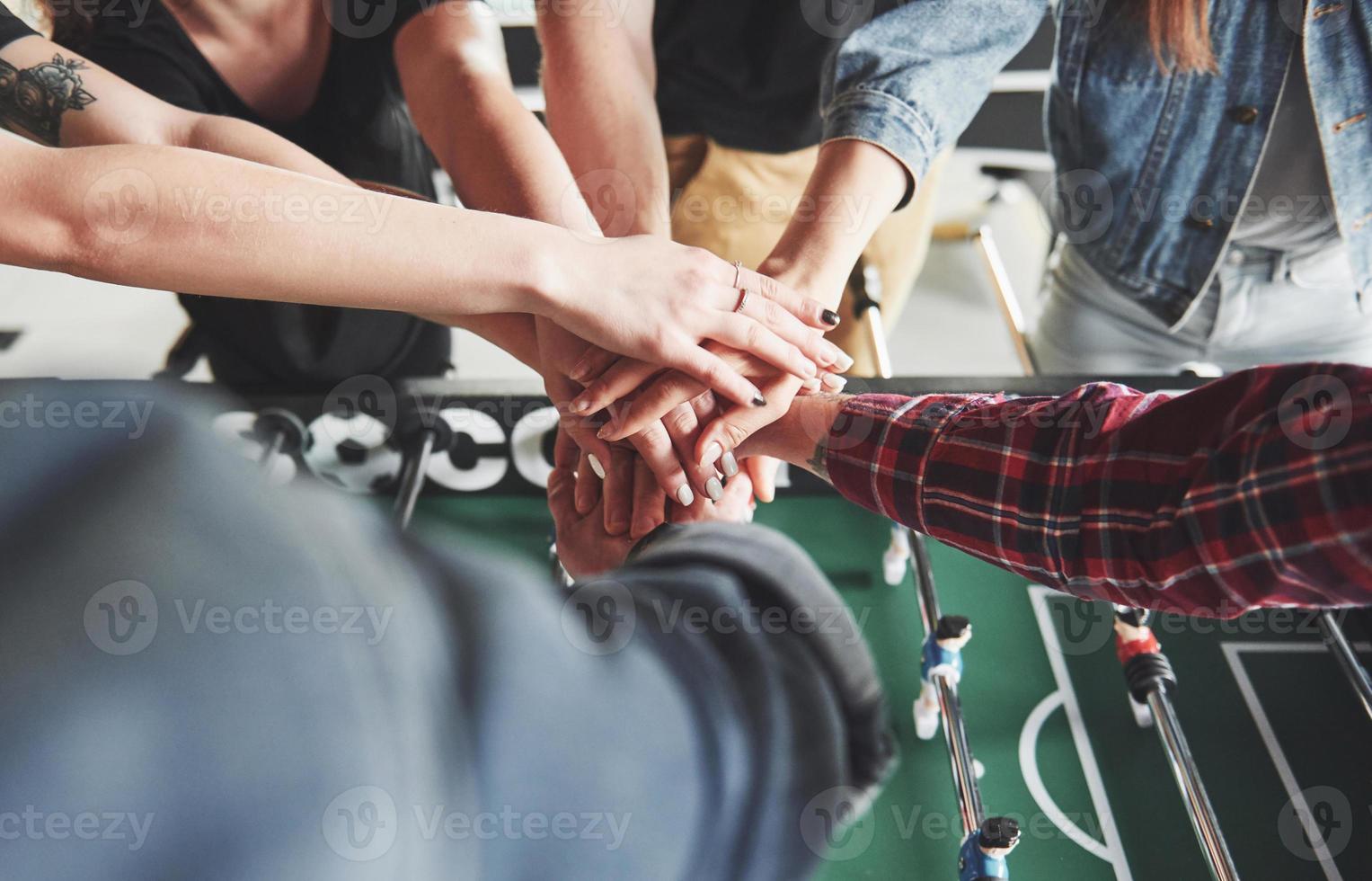 Friends together play board games, table football, have fun free time. photo