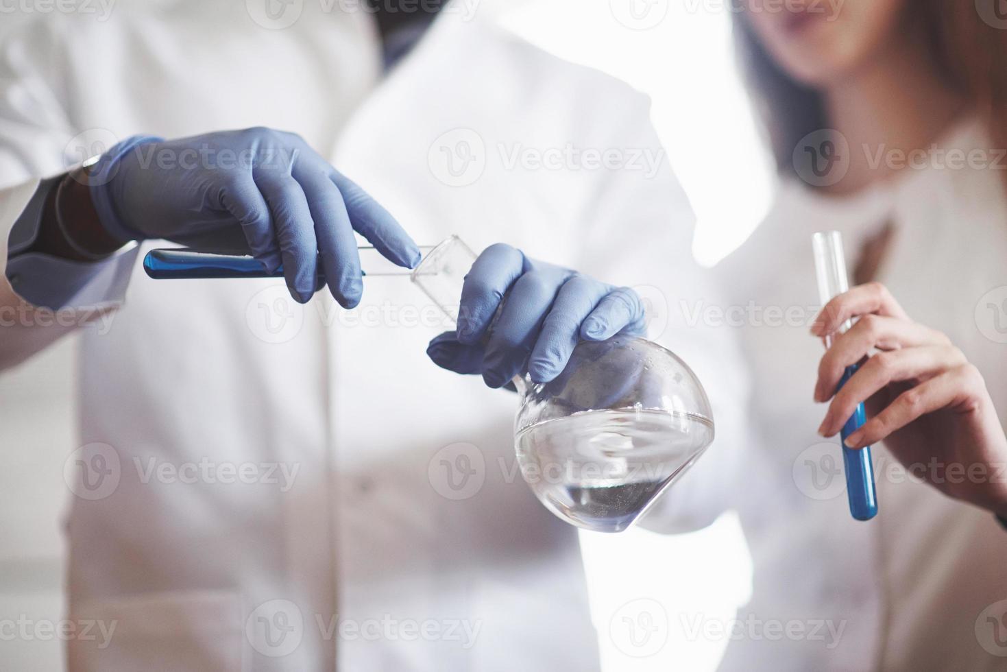 Experiments in the chemical laboratory. An experiment was carried out in a laboratory in transparent flasks photo