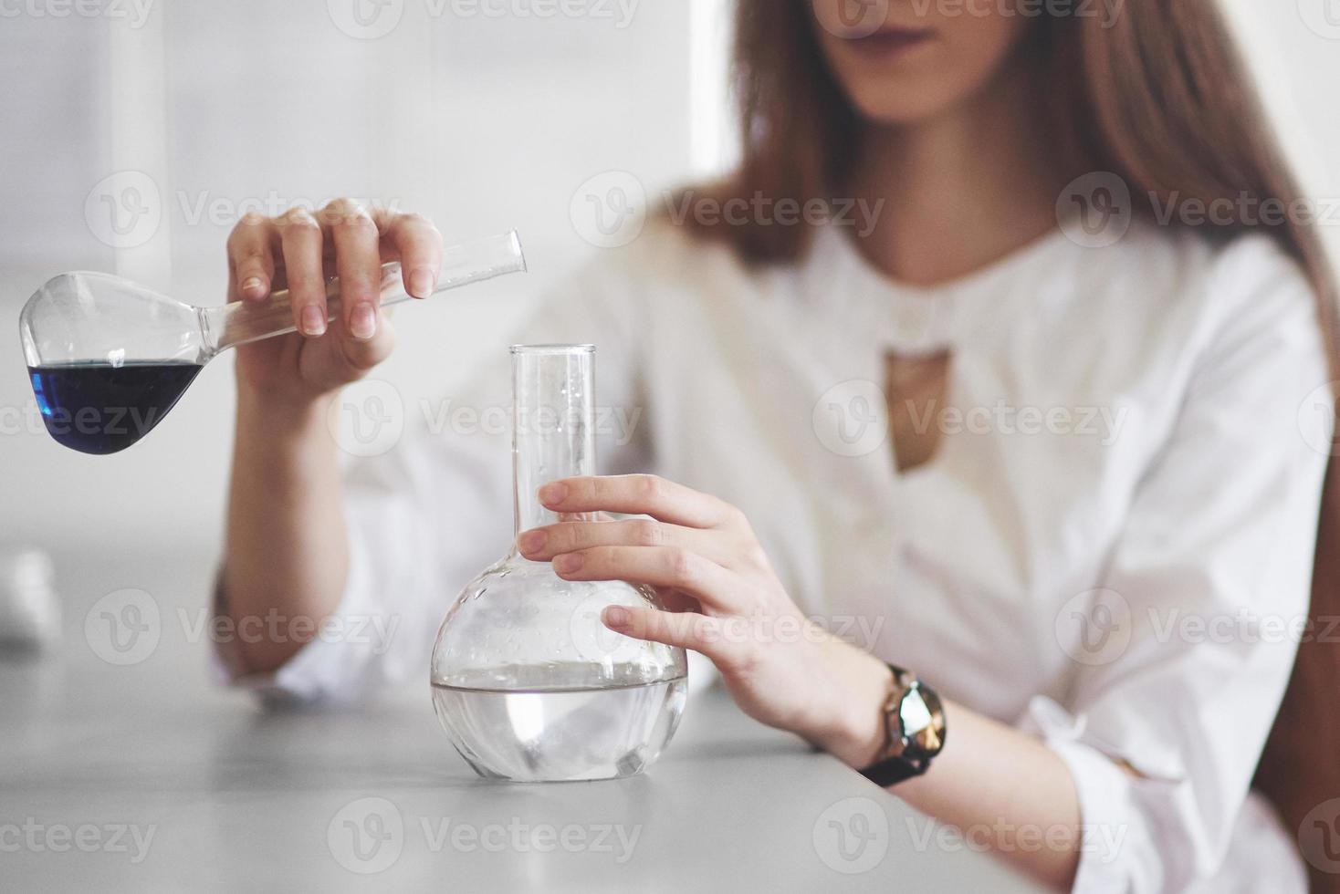 Experiments in the chemical laboratory. An experiment was carried out in a laboratory in transparent flasks photo