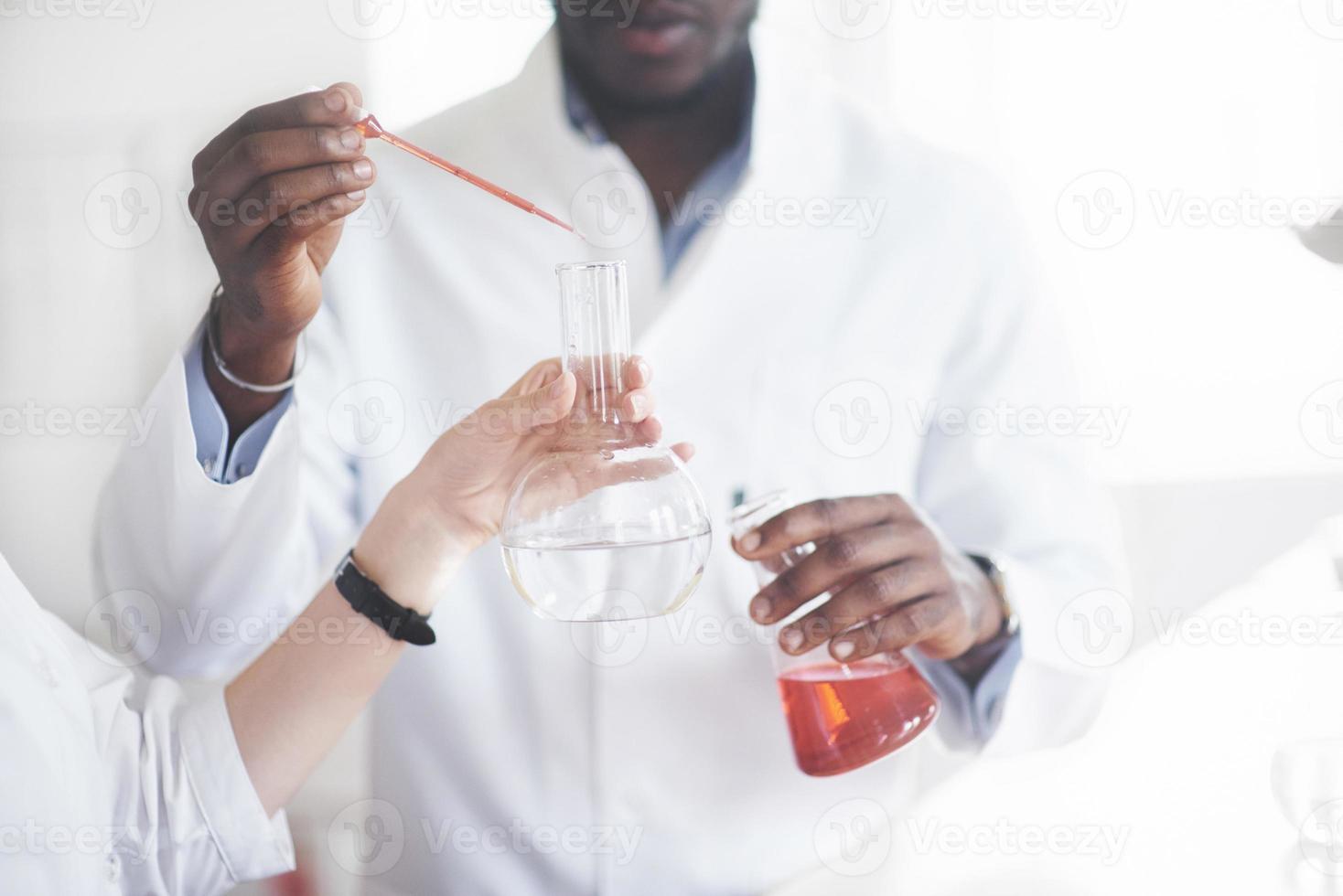 Experiments in the chemical laboratory. An experiment was carried out in a laboratory in transparent flasks photo