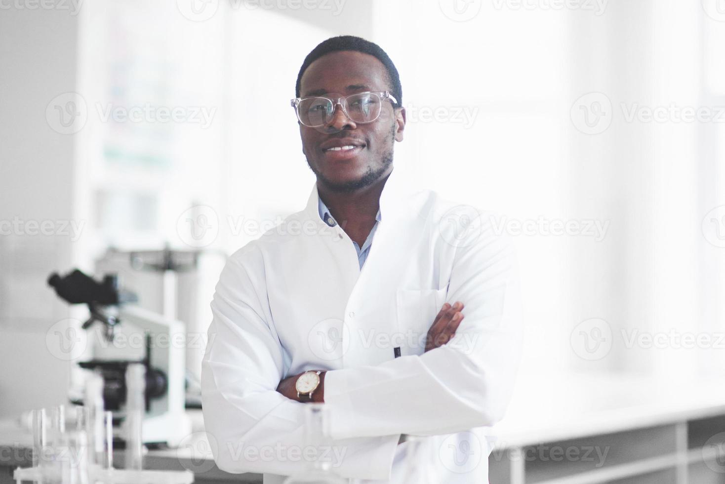 An African American worker works in a laboratory conducting experiments. photo