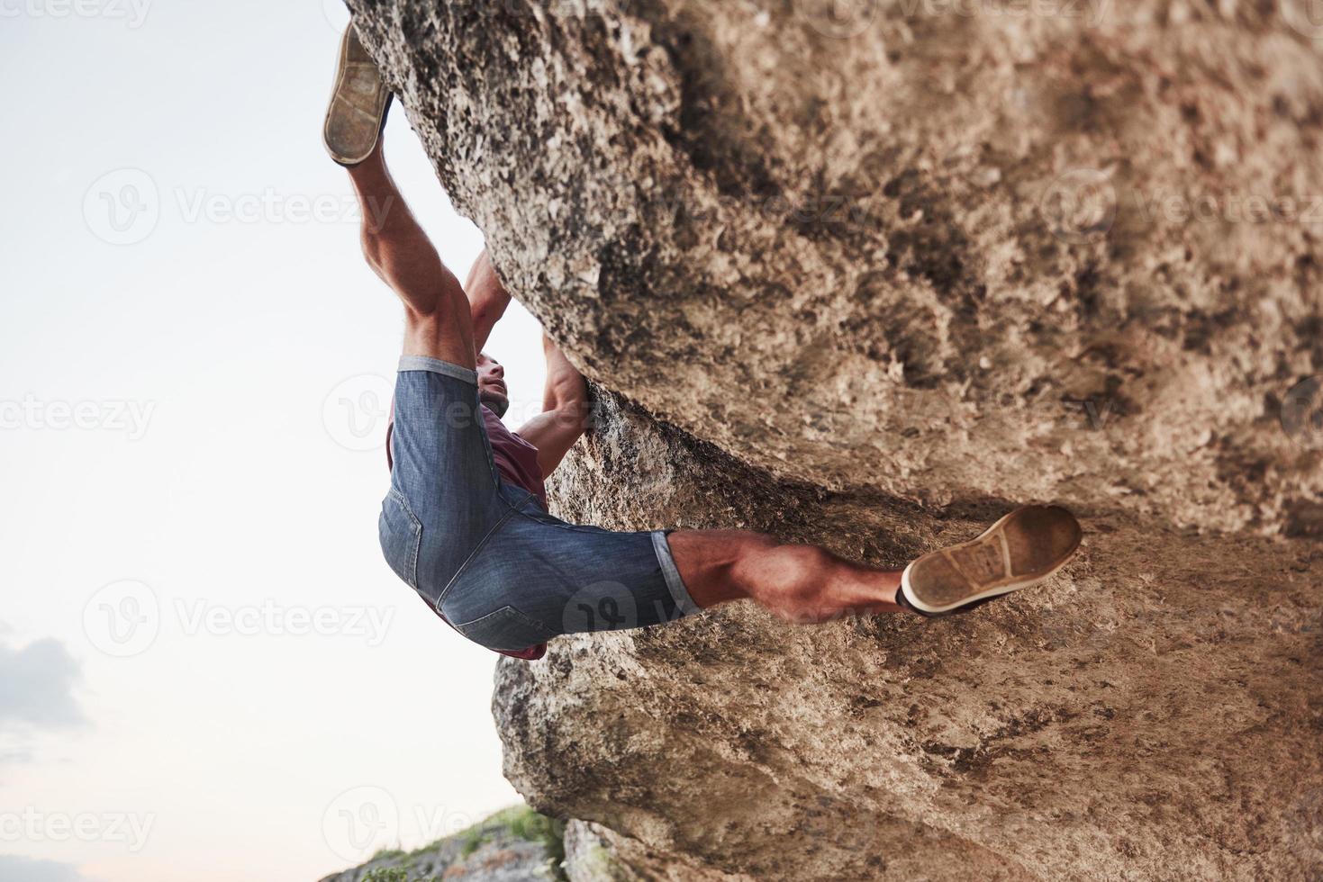 A young man climbers climb a rock. Extreme rest, style of life free and strong in spirit people photo