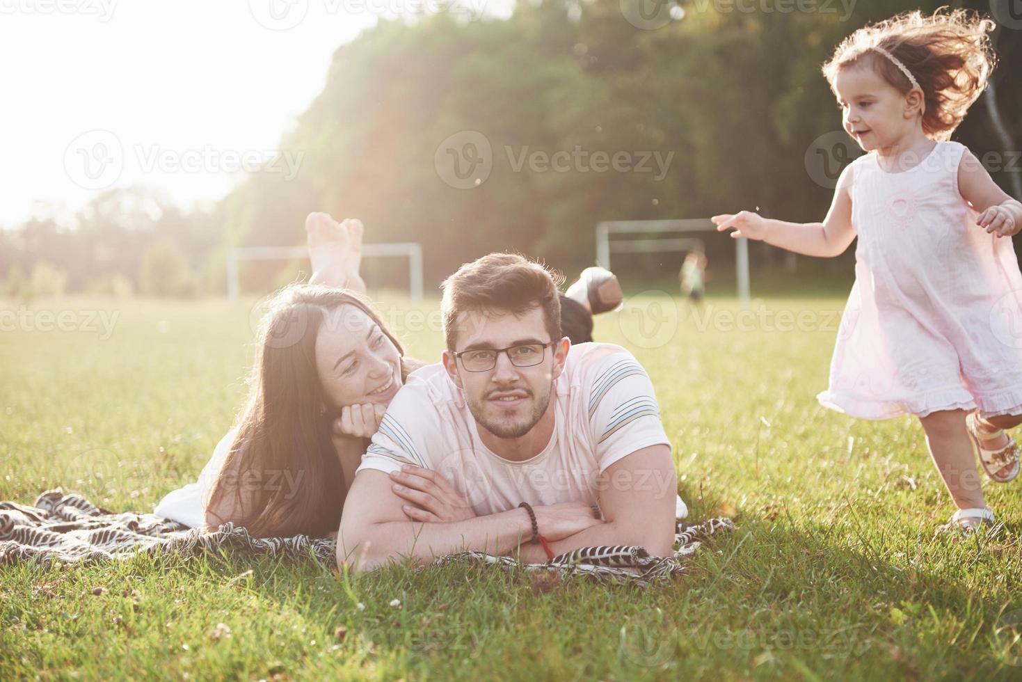 Happy family, father of mother and daughter of baby in the nature at sunset photo