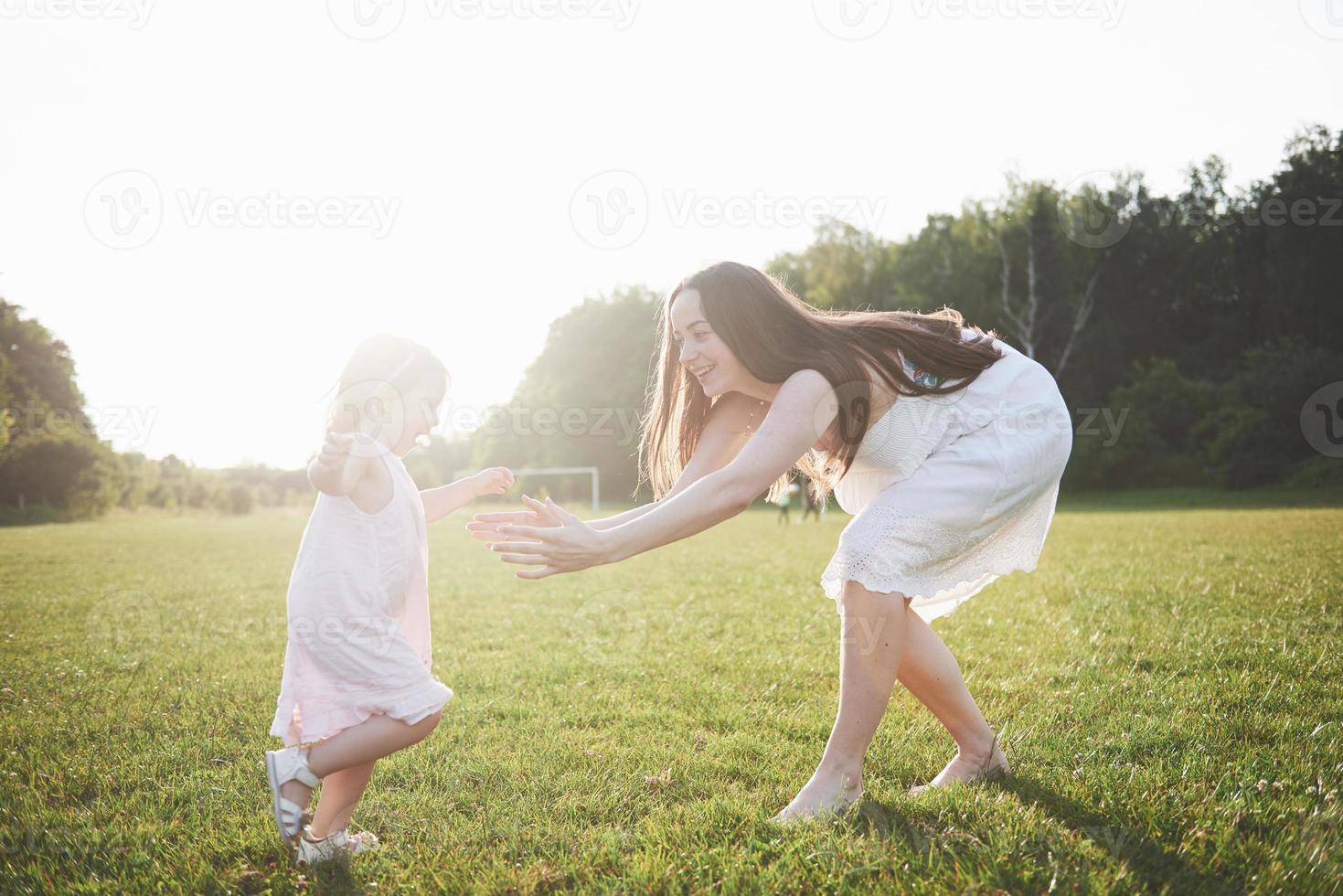 baby girl with mother on summer sunny day. photo