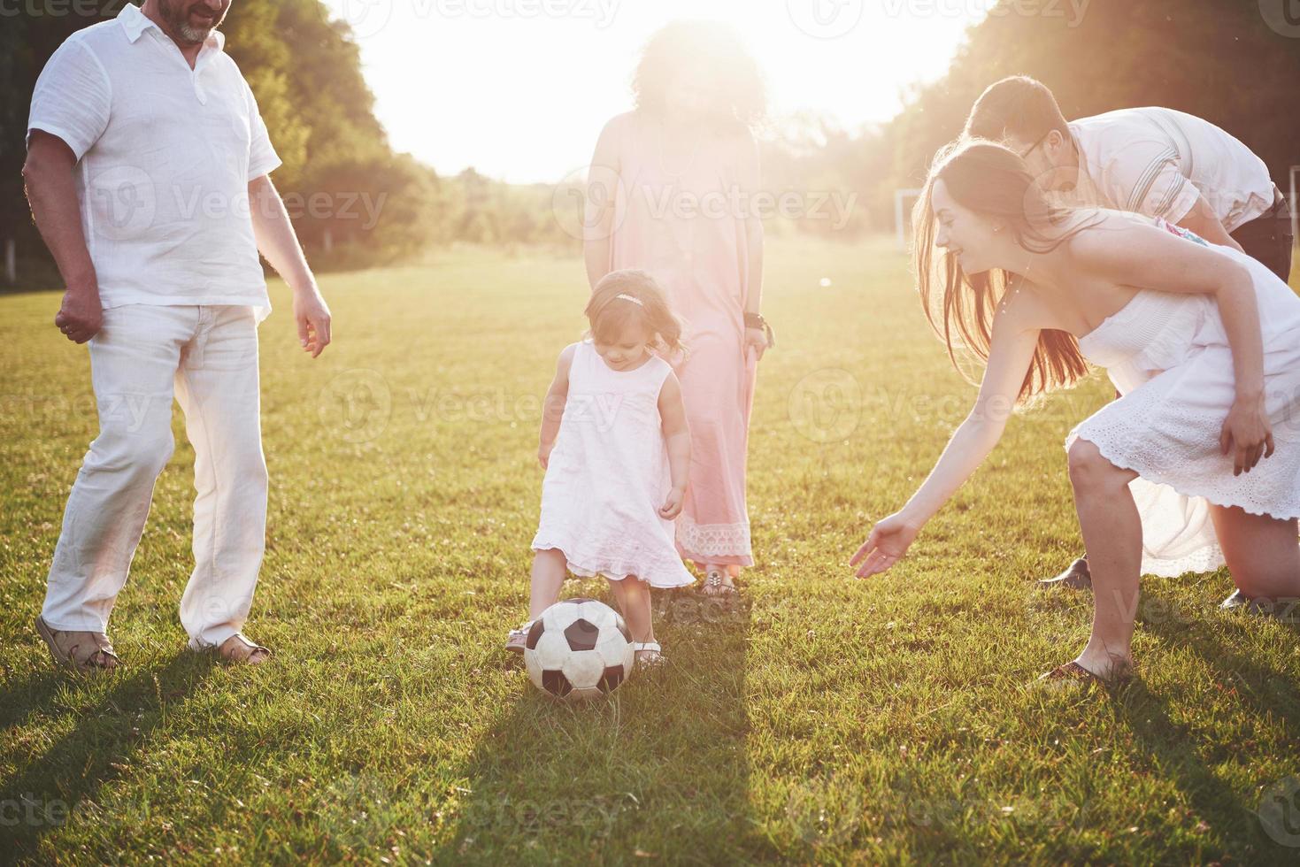 Cheerful active family having fun at countryside in summer day. photo