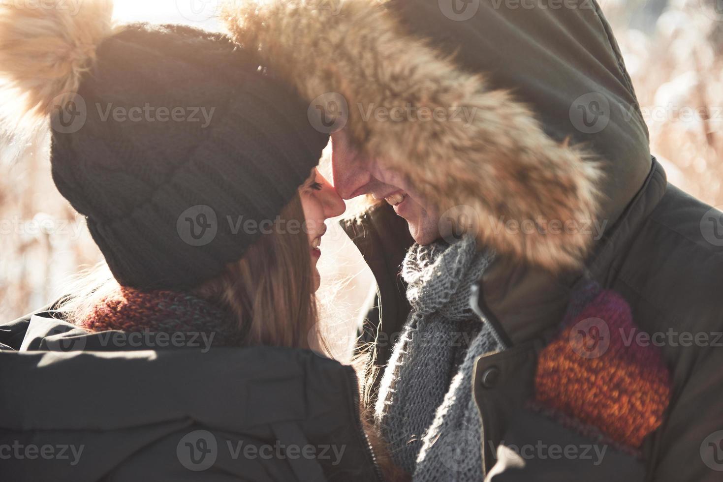 Happy couple playful together during winter holidays vacation outside in snow park photo