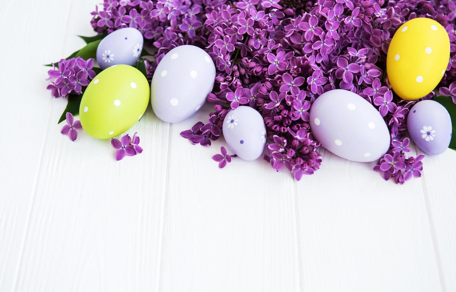 Spring lilac flowers and easter eggs photo