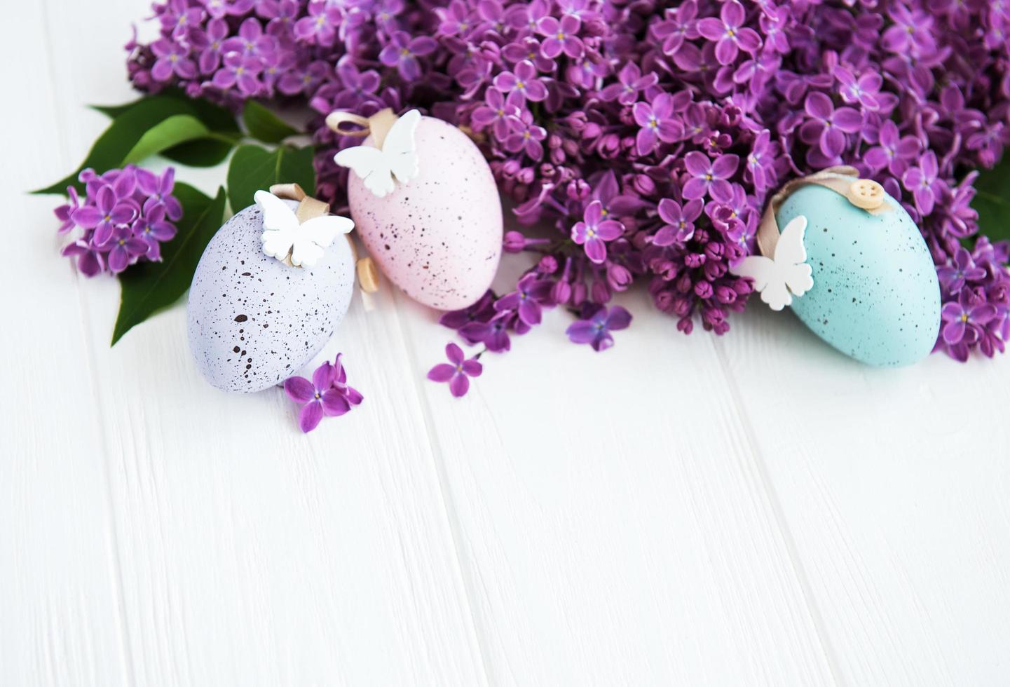 Spring lilac flowers and easter eggs photo