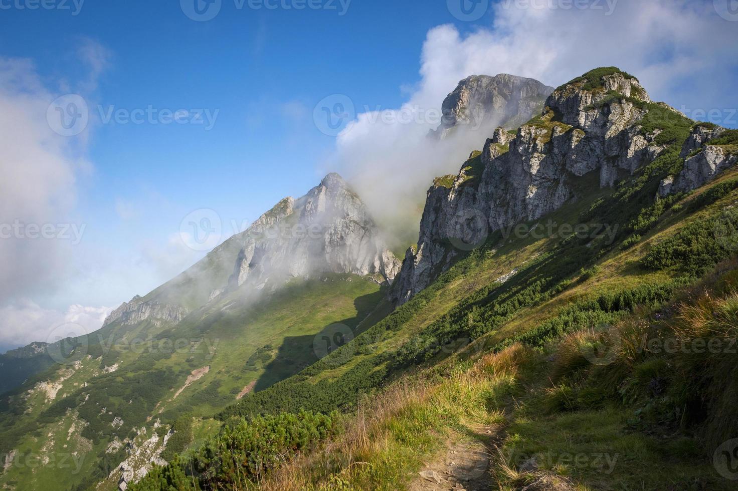 rocky peak surrounded by fog photo