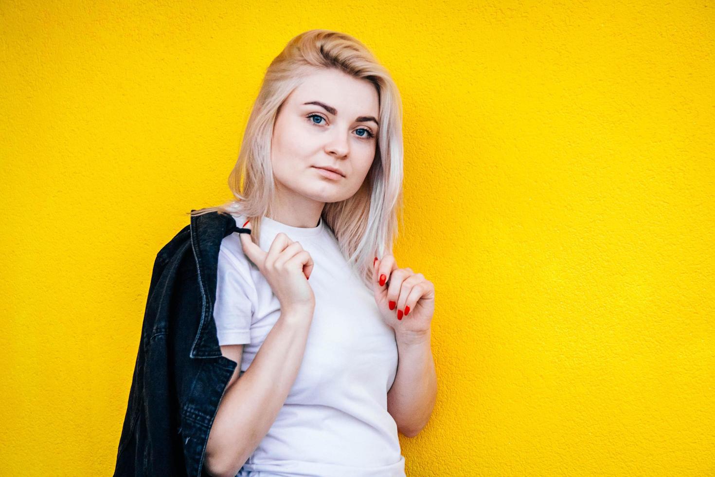 Woman posing against a background of yellow wall photo